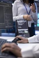 Teamworking admins in server farm checking recovery plan, monitoring energy consumption. Coworkers in data center making sure sensors are functioning optimally, doing routine disk checks, close up photo