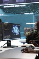 IT analyst managing satellite radar systems in modern control tower, overseeing intelligence activities and interpreting real time data. National interests for a defense mission. Close up. photo