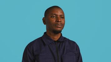 Headshot portrait of security guard at work smiling and overseeing premises. Joyful private law enforcement worker grinning while doing job, close up shot, studio backdrop, camera B photo