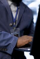 Software developer in data center uses laptop to identify and solve issues related to data center infrastructure. Close up of worker managing, maintaining and securing server farm environment photo