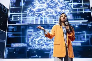 IT professional talking in mic at technology summit, explaining impact of AI technology on world. Tech company CEO presenting ethical risks and threats associated with AI photo