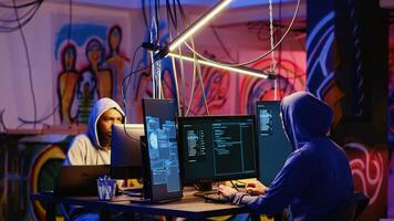 Hackers rushing to change their location after doing financial theft in dark bunker. Cybercriminals hiding their identity, removing any traces after stealing users bank account credentials photo