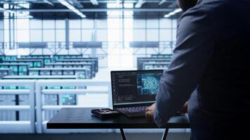 Engineer in server hub works with artificial intelligence computerized model simulating human brain. Man working on laptop with AI machine learning algorithms using pattern recognition, camera B photo