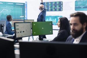 Business analyst reviewing performance indicators in office space, looking at a pc display with isolated copy space. Woman working on enterprise global expansion plans. Teamwork. photo