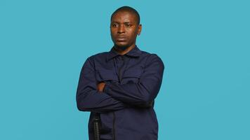 Security guard in threatening pose, tasked with preventing criminal activity and detaining suspects performing crimes. Portrait of menacing bodyguard crossing arms, studio background, camera A photo
