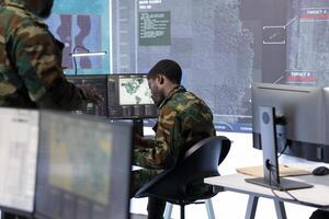 Military specialists work in a high tech command post center, focusing on cybersecurity, surveillance and data protection to ensure the security and integrity of national information. photo