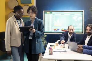 Business colleagues examining success and efficiency metrics within the firm, presenting project insight. Employees evaluating statistics and data reports, team productivity and progress. photo