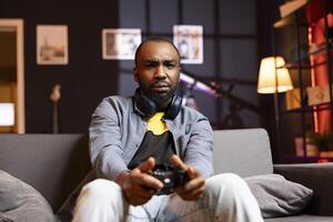 Portrait of irked gamer annoyed after losing in online singleplayer videogame played using controller. Man frustrated after failing to win game while playing on console with gamepad photo