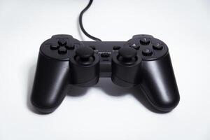 Black controller on white background, game device, Joystick on a white background. photo