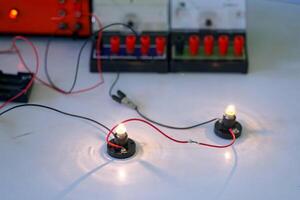 students are conducting experiments on basic electrical circuits. Concept of science classroom, learning science, science skills, learning, science experiments. photo