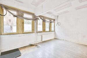 An empty room with a window and a floor photo