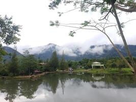 View of lake and and mountain with fog in it, at a campsite photo