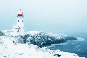 Winter lighthouse standing tall on a rocky coastline photo