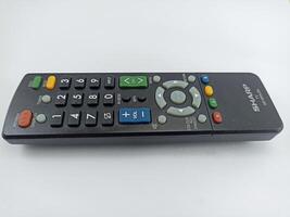 Wonosobo, Central Java Indonesia - August 9 2024 a sharp black TV remote control with a white background photo