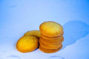 Danish butter cookies, stack of golden chocolate butter cookies isolated on white background, sweet pastry photo