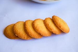 Danish butter cookies, stack of golden chocolate butter cookies isolated on white background, sweet pastry photo