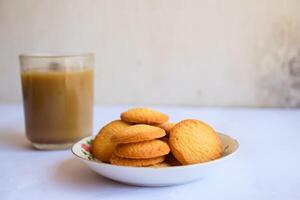 breakfast menu in the form of Danish butter cake and a glass of chocolate milk, Close up of butter cookies coated with white sugar and a glass of chocolate, sweet cake photo