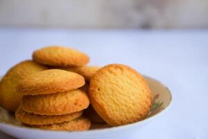 Danish butter cookies, stack of golden chocolate butter cookies isolated on white background, sweet pastry photo