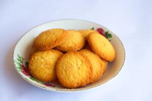 Danish butter cookies, stack of golden chocolate butter cookies isolated on white background, sweet pastry photo