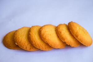 Danish butter cookies, stack of golden chocolate butter cookies isolated on white background, sweet pastry photo