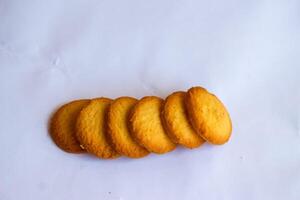 Danish butter cookies, stack of golden chocolate butter cookies isolated on white background, sweet pastry photo