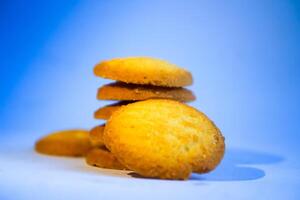 Danish butter cookies, stack of golden chocolate butter cookies isolated on white background, sweet pastry photo