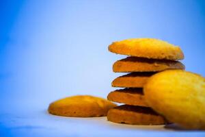 Danish butter cookies, stack of golden chocolate butter cookies isolated on white background, sweet pastry photo