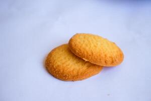 Danish butter cookies, stack of golden chocolate butter cookies isolated on white background, sweet pastry photo