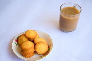 breakfast menu in the form of Danish butter cake and a glass of chocolate milk, Close up of butter cookies coated with white sugar and a glass of chocolate, sweet cake photo