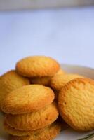 Danish butter cookies, stack of golden chocolate butter cookies isolated on white background, sweet pastry photo