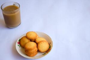 breakfast menu in the form of Danish butter cake and a glass of chocolate milk, Close up of butter cookies coated with white sugar and a glass of chocolate, sweet cake photo
