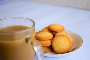breakfast menu in the form of Danish butter cake and a glass of chocolate milk, Close up of butter cookies coated with white sugar and a glass of chocolate, sweet cake photo