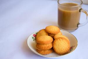 breakfast menu in the form of Danish butter cake and a glass of chocolate milk, Close up of butter cookies coated with white sugar and a glass of chocolate, sweet cake photo