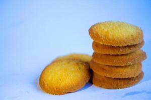 Danish butter cookies, stack of golden chocolate butter cookies isolated on white background, sweet pastry photo
