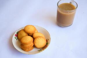 breakfast menu in the form of Danish butter cake and a glass of chocolate milk, Close up of butter cookies coated with white sugar and a glass of chocolate, sweet cake photo