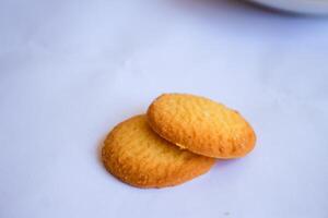 Danish butter cookies, stack of golden chocolate butter cookies isolated on white background, sweet pastry photo