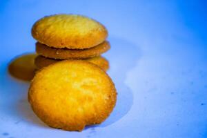 Danish butter cookies, stack of golden chocolate butter cookies isolated on white background, sweet pastry photo