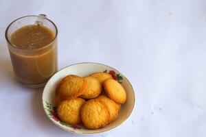 breakfast menu in the form of Danish butter cake and a glass of chocolate milk, Close up of butter cookies coated with white sugar and a glass of chocolate, sweet cake photo