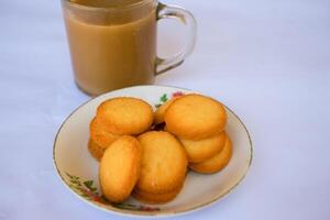 breakfast menu in the form of Danish butter cake and a glass of chocolate milk, Close up of butter cookies coated with white sugar and a glass of chocolate, sweet cake photo