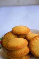 Danish butter cookies, stack of golden chocolate butter cookies isolated on white background, sweet pastry photo