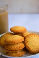 breakfast menu in the form of Danish butter cake and a glass of chocolate milk, Close up of butter cookies coated with white sugar and a glass of chocolate, sweet cake photo
