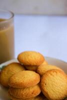 breakfast menu in the form of Danish butter cake and a glass of chocolate milk, Close up of butter cookies coated with white sugar and a glass of chocolate, sweet cake photo