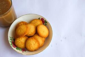 breakfast menu in the form of Danish butter cake and a glass of chocolate milk, Close up of butter cookies coated with white sugar and a glass of chocolate, sweet cake photo