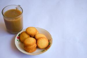 breakfast menu in the form of Danish butter cake and a glass of chocolate milk, Close up of butter cookies coated with white sugar and a glass of chocolate, sweet cake photo