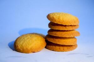 Danish butter cookies, stack of golden chocolate butter cookies isolated on white background, sweet pastry photo