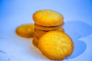 Danish butter cookies, stack of golden chocolate butter cookies isolated on white background, sweet pastry photo