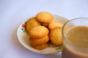 breakfast menu in the form of Danish butter cake and a glass of chocolate milk, Close up of butter cookies coated with white sugar and a glass of chocolate, sweet cake photo