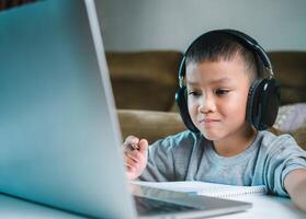 Online education, Technology studying at home using laptop computer, Student distance learning virtual distance online class on call virtual lesson, Teaching child boy with remote education. photo