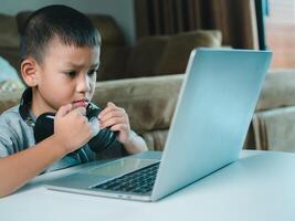 Online education, Technology studying at home using laptop computer, Student distance learning virtual distance online class on call virtual lesson, Teaching child boy with remote education. photo