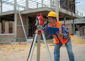 Civil engineer or Architect working surveyor, Surveyor and survey equipment on construction site, Land and soil development, Survey equipment, Theodolite for measurement construction work. photo